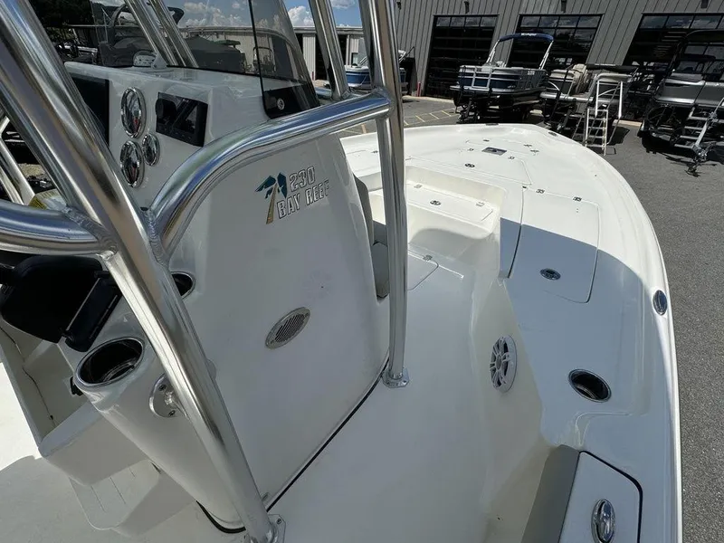 Slide: The Image of 2025 Key West 230 BR boat interior with steering console and seating area. - 16