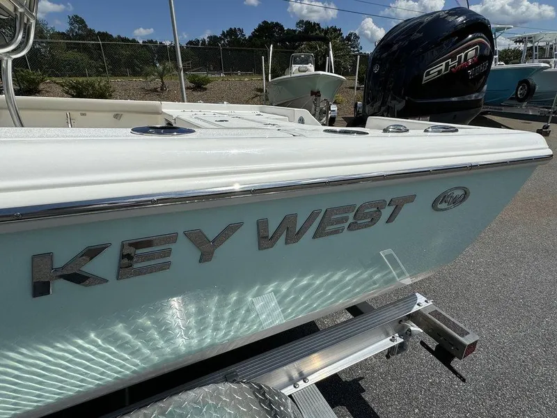 Slide: The Image of 2025 Key West 230 BR boat on trailer, outdoor display. - 4