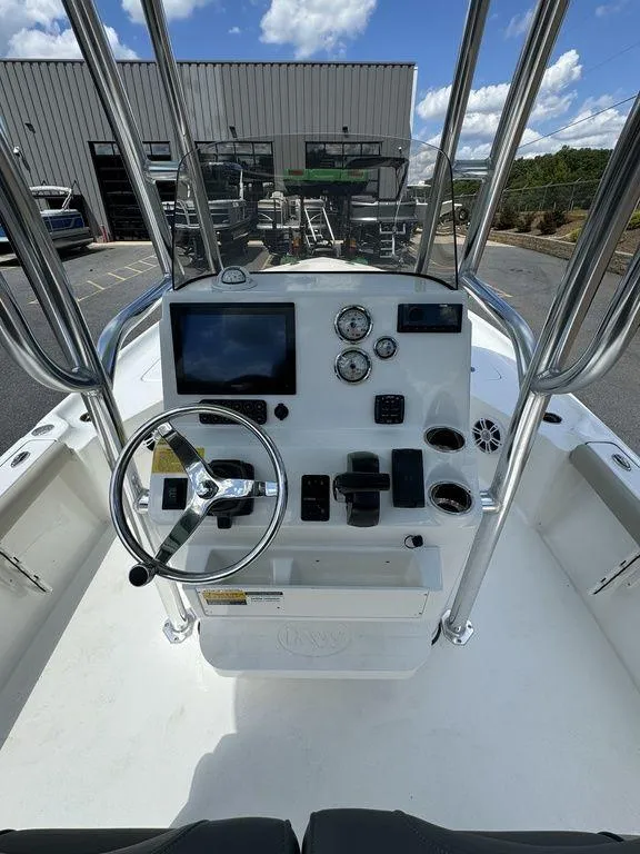 Slide: The Image of 2025 Key West 230 BR boat dashboard with steering wheel and navigation controls. - 7