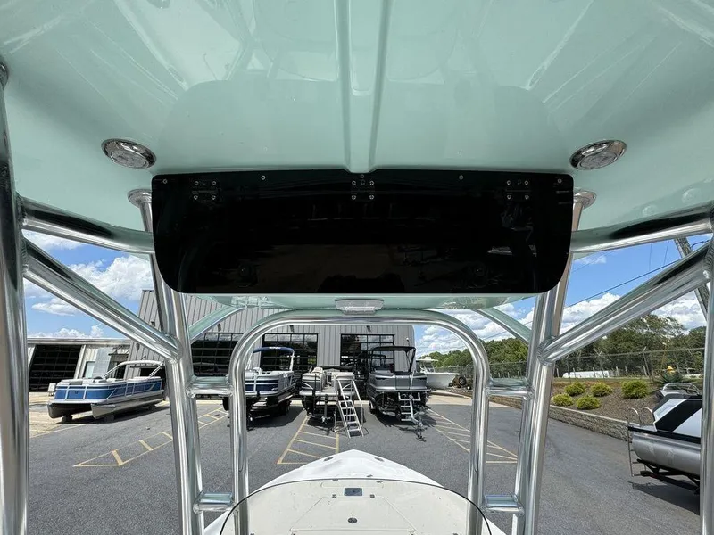 Slide: The Image of 2025 Key West 230 BR boat interior with view of marina and parked boats. - 8
