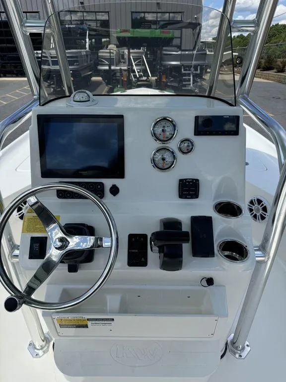 Slide: The Image of 2025 Key West 230 BR boat console with steering wheel and gauges. - 9