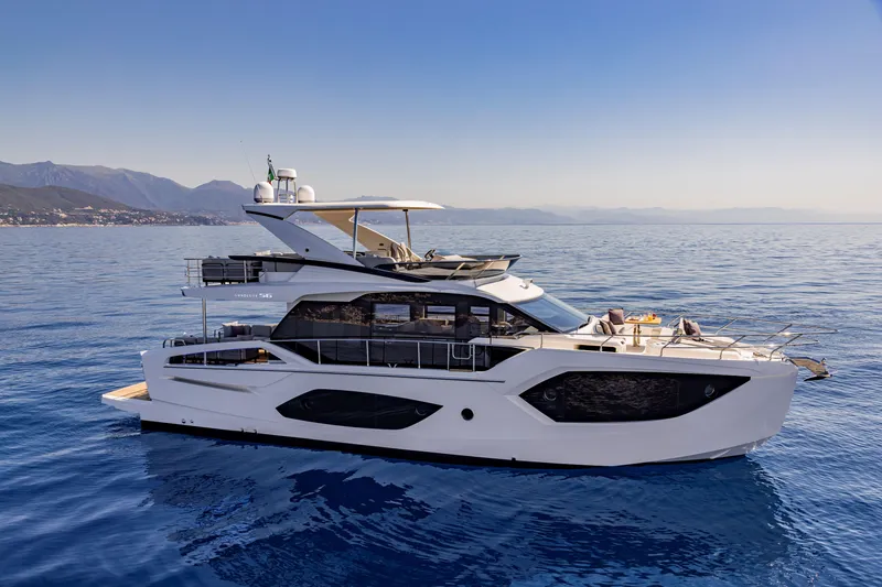 Slide: The Image of Luxurious 2025 Absolute 56 FLY yacht cruising on serene blue waters. - 0