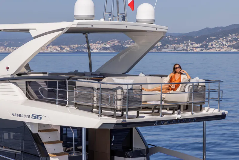 Slide: The Image of Luxury yacht Absolute 56 FLY 2025 with woman relaxing on upper deck. - 10