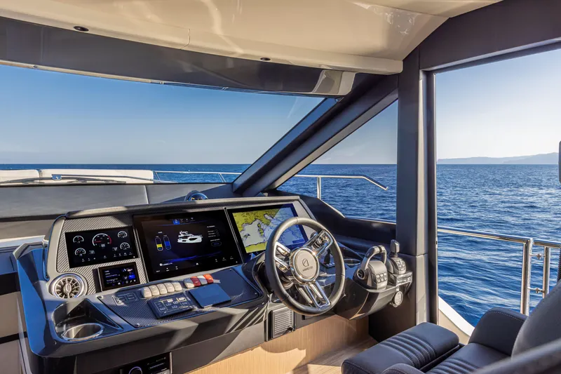 Slide: The Image of 2025 Absolute 56 FLY yacht cockpit with modern navigation system, overlooking the ocean. - 14