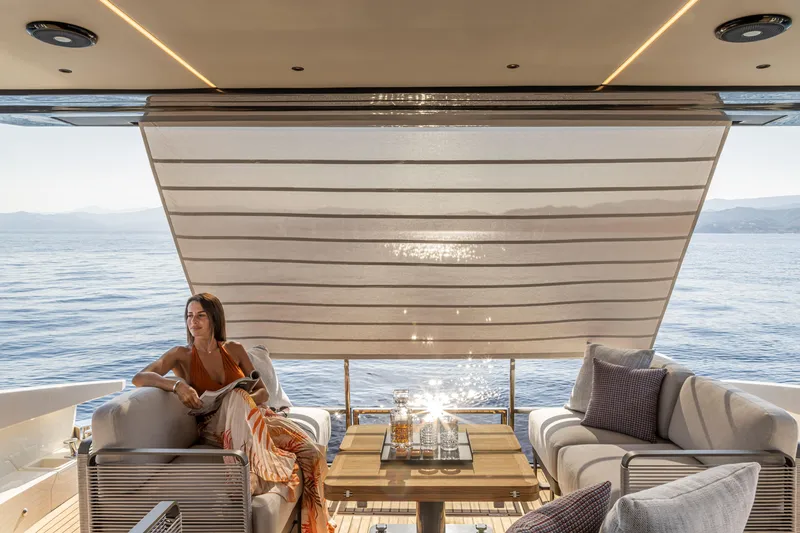 Slide: The Image of Luxury yacht Absolute 56 FLY 2025, elegant deck seating with ocean view. - 15