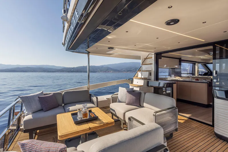 Slide: The Image of Luxurious 2025 Absolute 56 FLY yacht with elegant outdoor seating and ocean view. - 16