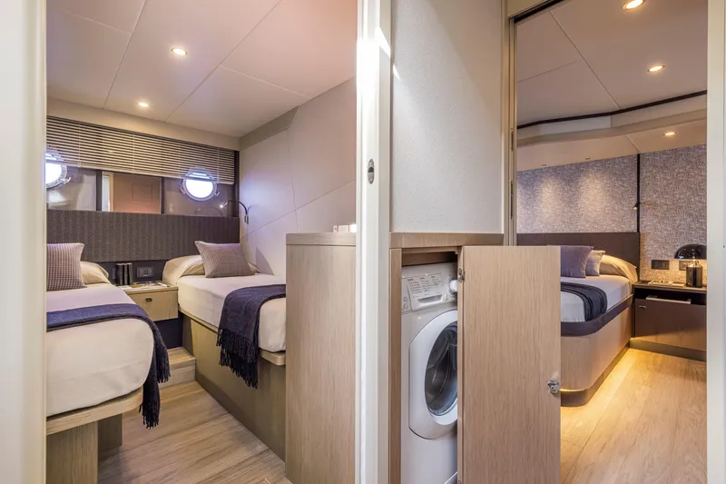 Slide: The Image of Luxurious interior of 2025 Absolute 56 FLY yacht with modern twin bedrooms and washer. - 25