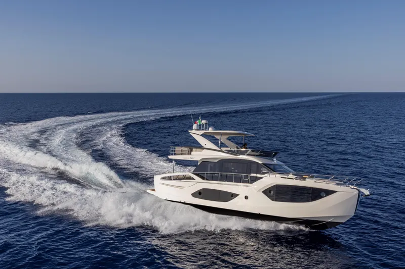 Slide: The Image of 2025 Absolute 56 FLY yacht cruising on open sea. - 4