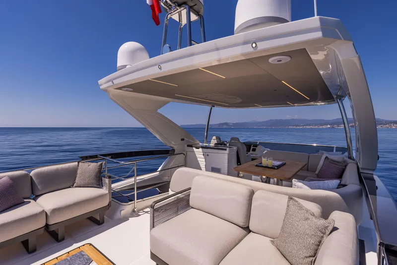 Slide: The Image of Luxury Absolute 56 FLY yacht deck, 2025 model, with elegant seating and ocean view. - 9