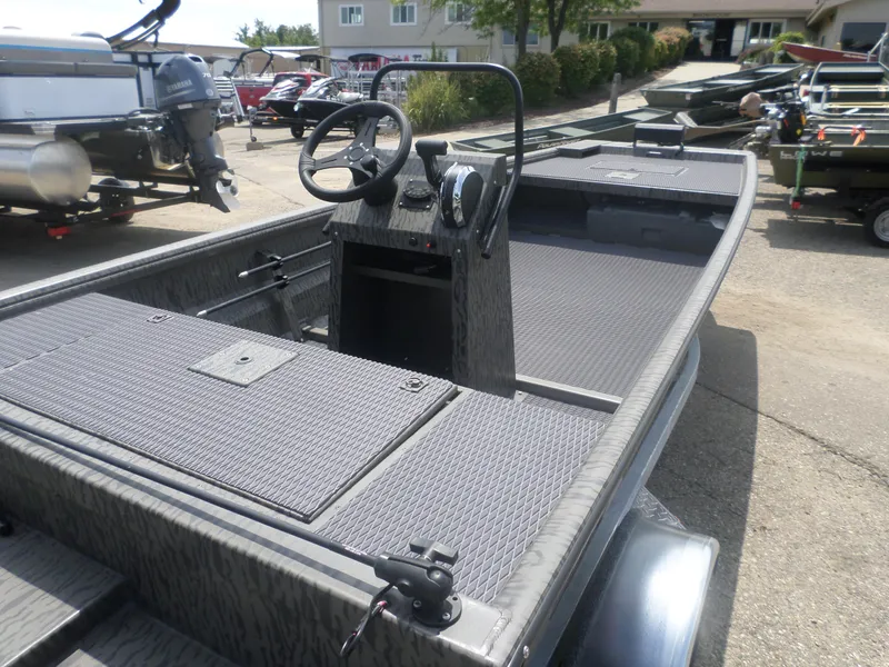 Slide: The Image of 2024 GATOR-TAIL 1860 Extreme CC boat with steering console, parked outdoors. - 4