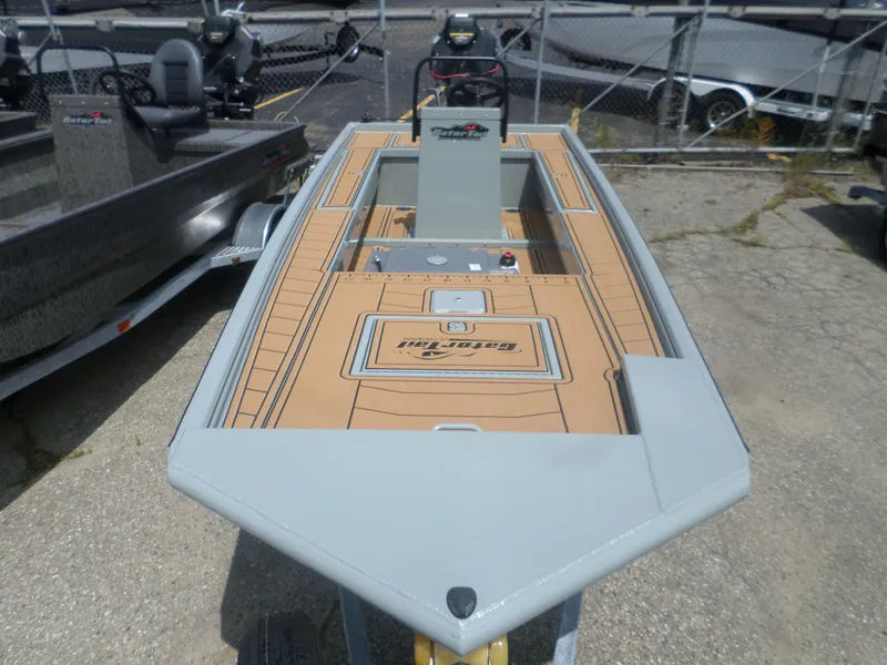Slide: The Image of 2024 GATOR-TAIL 1860 Extreme CC boat with tan deck, parked outdoors. - 2