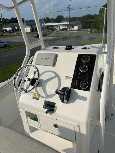 Slide: The Image of 2016 Clearwater 2200 WI Center Console boat dashboard with steering wheel and controls. - 5