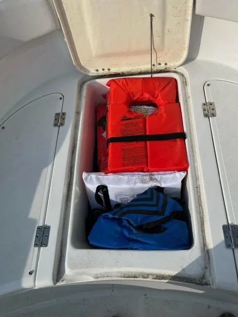 Slide: The Image of Storage compartment on 2016 Clearwater 2200 WI Center Console with life jackets and gear. - 9