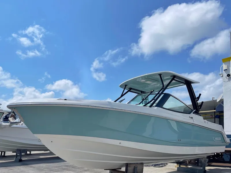 Slide: The Image of 2021 Boston Whaler 240 Vantage boat under a clear blue sky. - 11