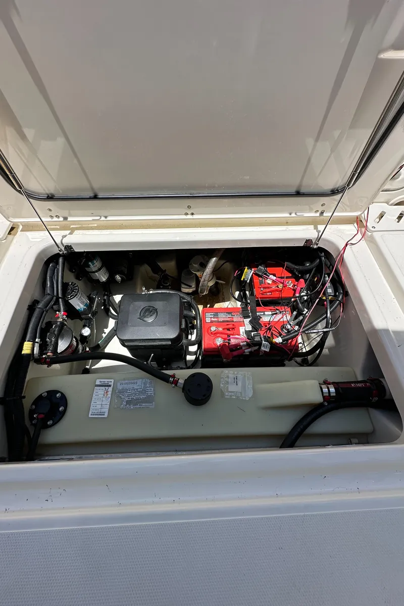 Slide: The Image of 2021 Boston Whaler 240 Vantage engine compartment with visible components and wiring. - 17