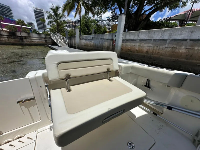 Slide: The Image of 2021 Boston Whaler 240 Vantage boat interior with seating, dockside view. - 6