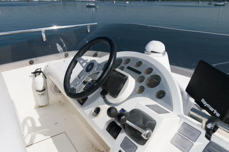 Slide: The Image of 2007 Fairline Phantom 46 yacht helm with steering wheel and navigation controls. - 11