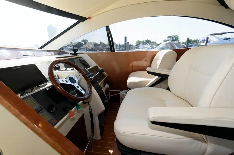 Slide: The Image of Interior of 2007 Fairline Phantom 46 yacht with leather seating and wooden steering wheel. - 19