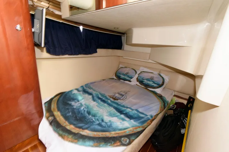Slide: The Image of 2007 Fairline Phantom 46 cabin with nautical-themed bedding and wooden accents. - 25
