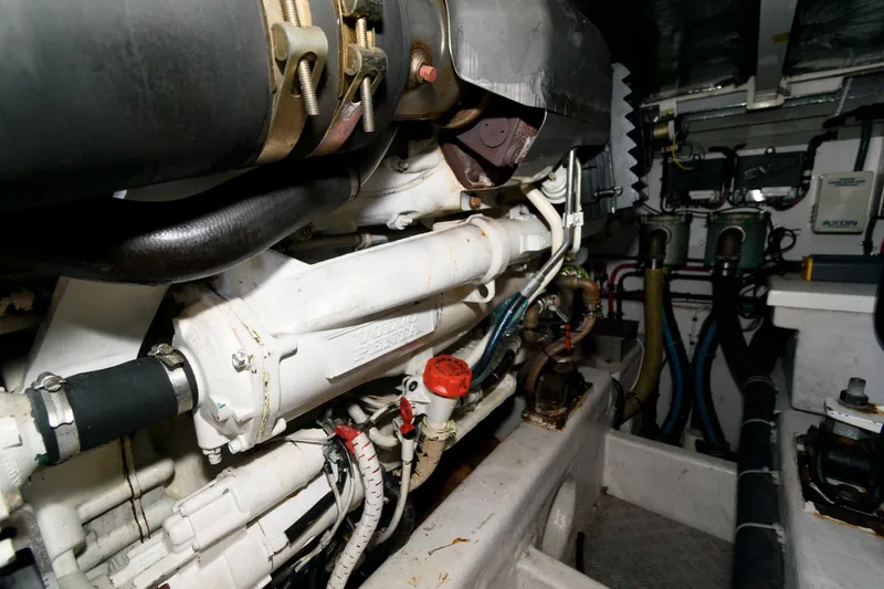Slide: The Image of Engine room of a 2007 Fairline Phantom 46 yacht, showcasing mechanical components and piping. - 32