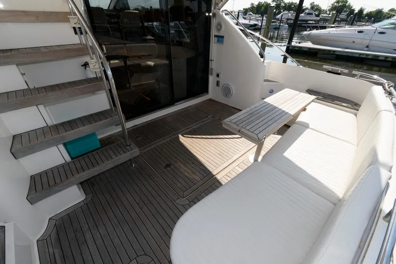 Slide: The Image of 2007 Fairline Phantom 46 yacht deck with seating and table, featuring teak flooring. - 4