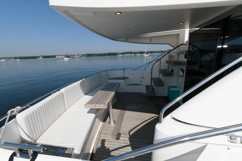 Slide: The Image of 2007 Fairline Phantom 46 yacht deck with seating, overlooking calm waters. - 5