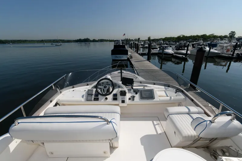 Slide: The Image of 2007 Fairline Phantom 46 yacht docked at marina, featuring spacious helm and seating area. - 9