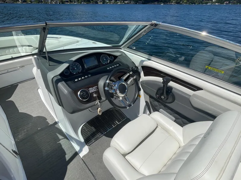 Slide: The Image of Interior of a 2011 Cobalt A25 boat with steering wheel and dashboard. - 14