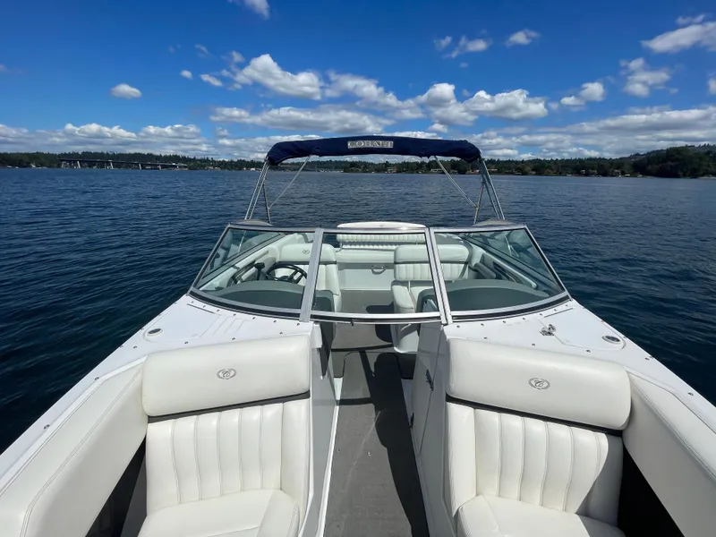 Slide: The Image of 2011 Cobalt A25 boat on a lake under a clear blue sky. - 19