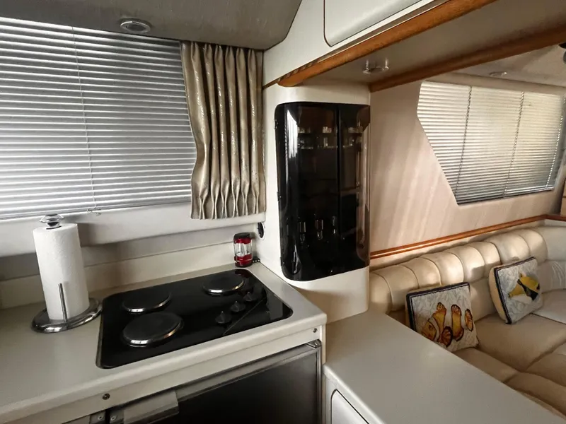Slide: The Image of Interior of 1990 Sea Ray Sedan Bridge 500 yacht with kitchen and seating area. - 10