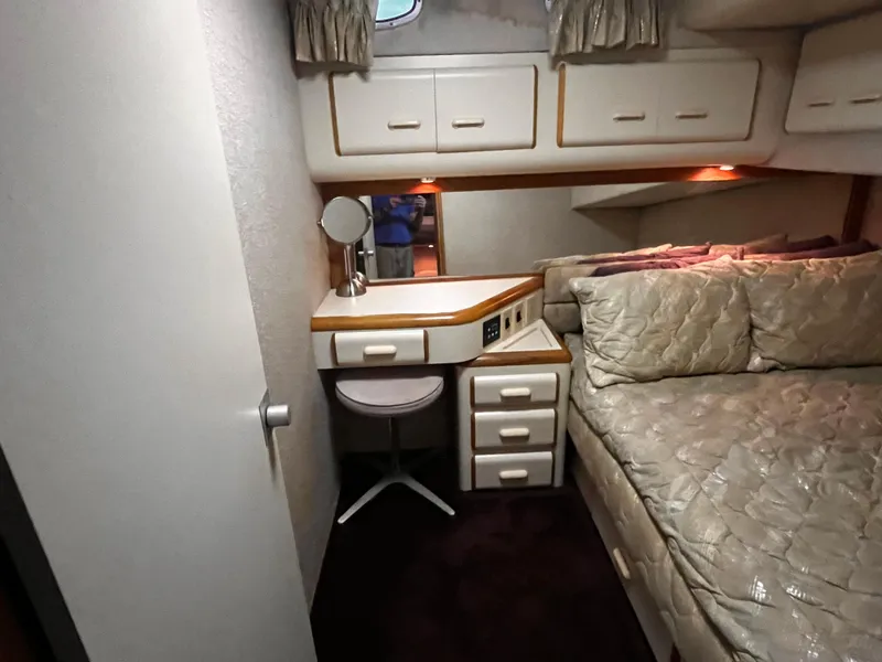 Slide: The Image of Cozy bedroom in 1990 Sea Ray Sedan Bridge 500 yacht with vanity and storage. - 17