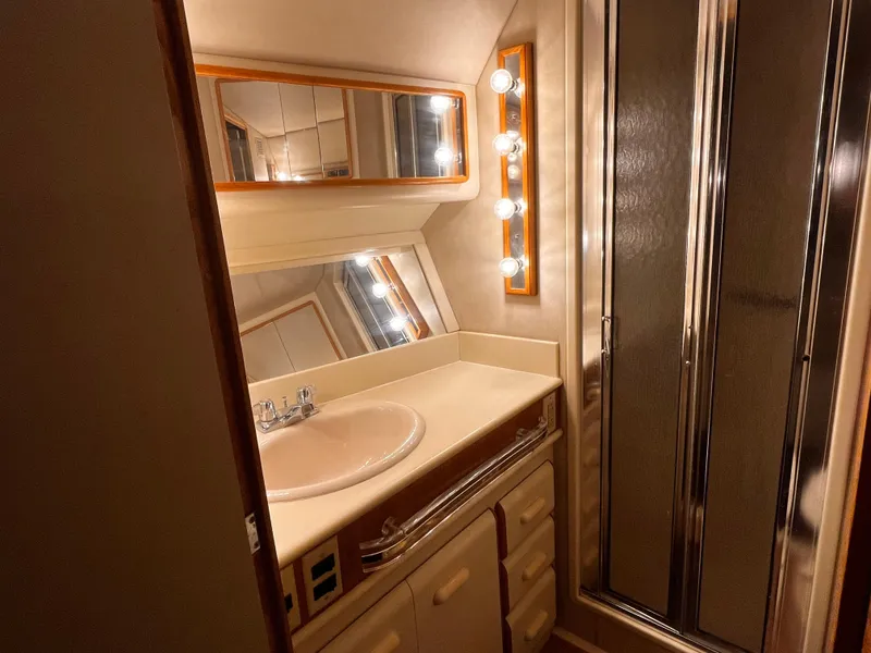 Slide: The Image of Luxurious bathroom in 1990 Sea Ray Sedan Bridge 500 yacht with vanity and shower. - 25
