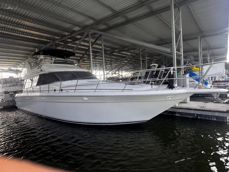 Slide: The Image of 1990 Sea Ray Sedan Bridge 500 docked under a covered marina. - 3
