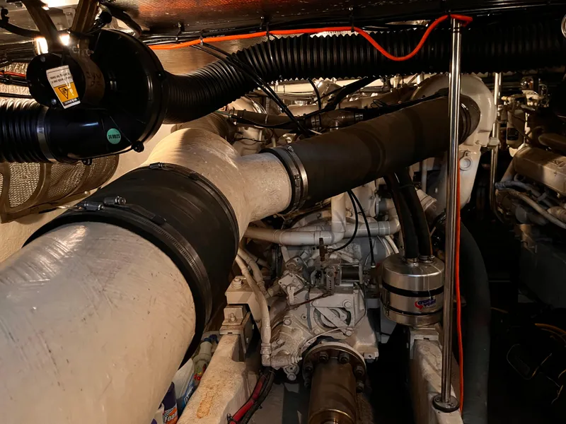 Slide: The Image of Engine room of 1990 Sea Ray Sedan Bridge 500 with visible exhaust pipes and components. - 32