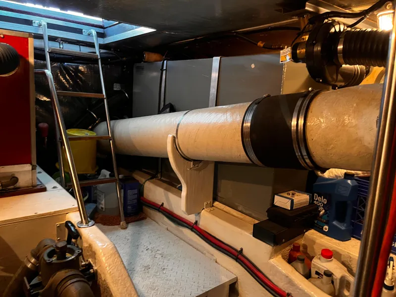 Slide: The Image of Engine room of 1990 Sea Ray Sedan Bridge 500 with visible exhaust system and maintenance tools. - 37