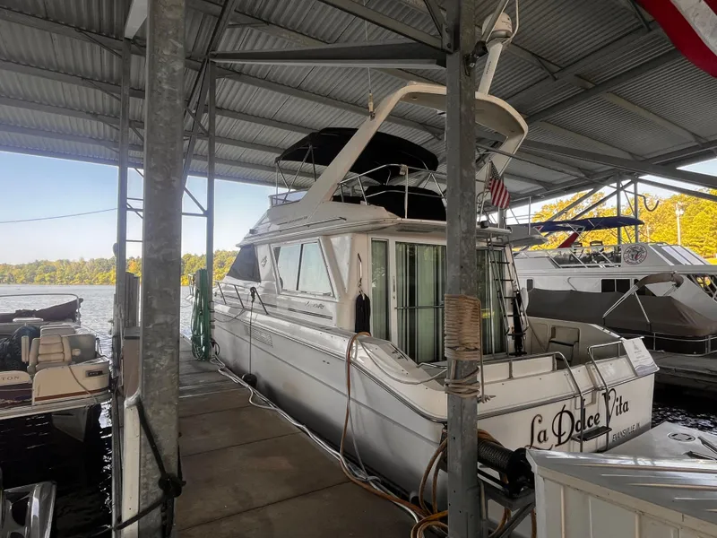 Slide: The Image of 1990 Sea Ray Sedan Bridge 500 docked under a covered marina. - 4