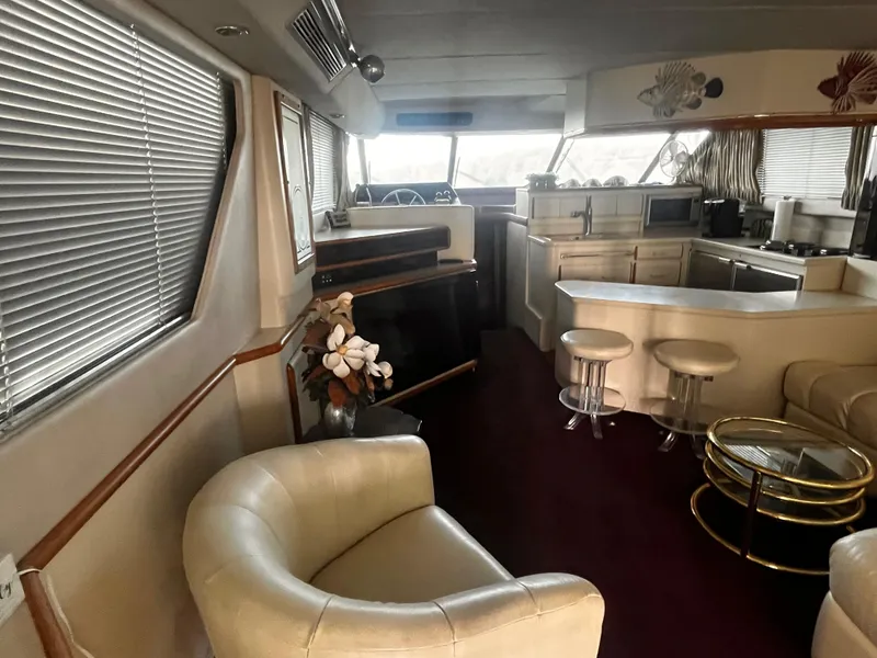 Slide: The Image of Luxurious interior of 1990 Sea Ray Sedan Bridge 500 yacht with modern furnishings. - 7