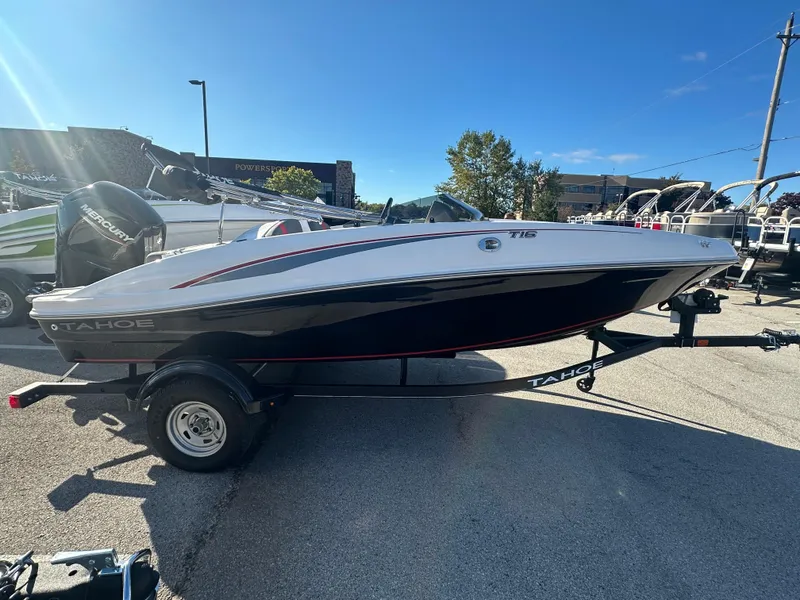 Slide: The Image of 2024 Tahoe T16 boat on trailer in outdoor showroom. - 2