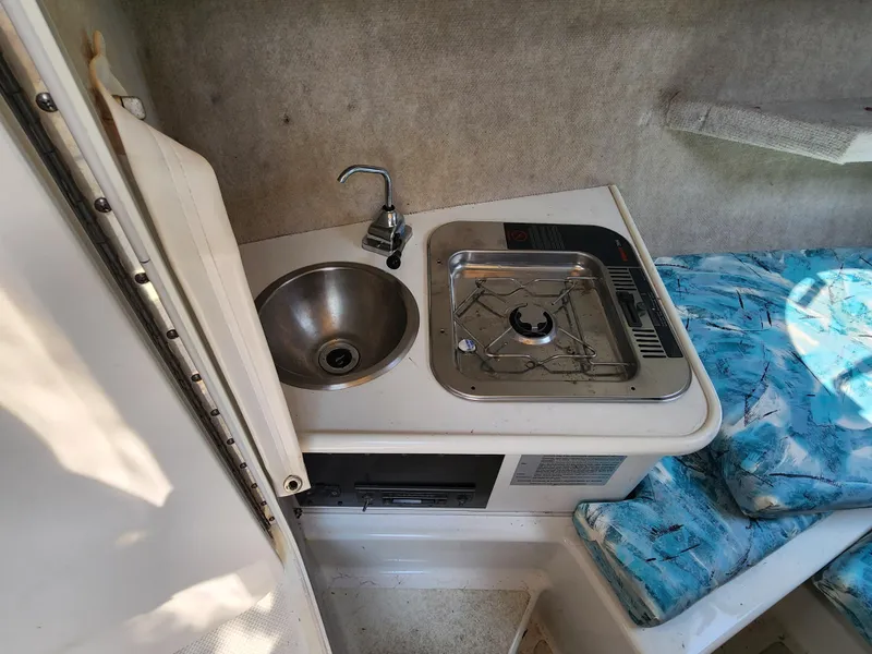 Slide: The Image of Compact kitchen area in 2000 Seaswirl Striper 2600 Walkaround I/O boat. - 14