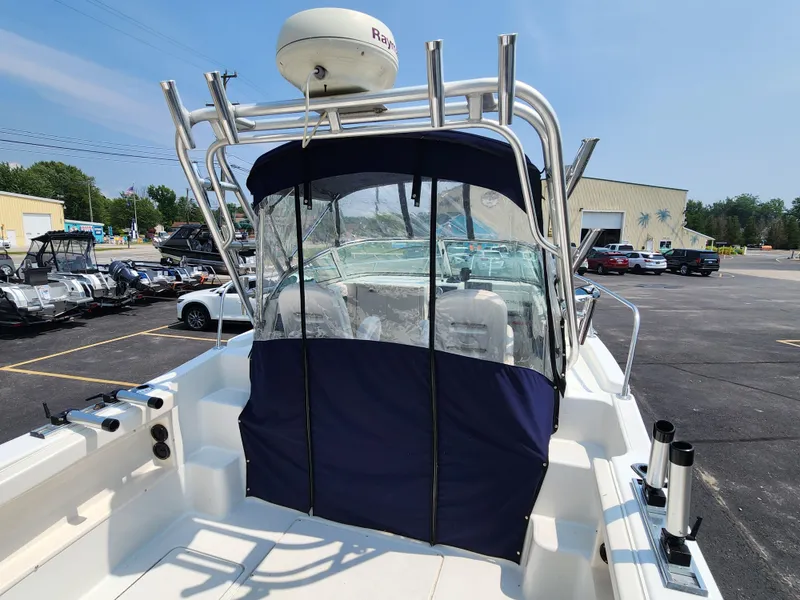 Slide: The Image of 2000 Seaswirl Striper 2600 Walkaround I/O boat with blue canopy in parking lot. - 5