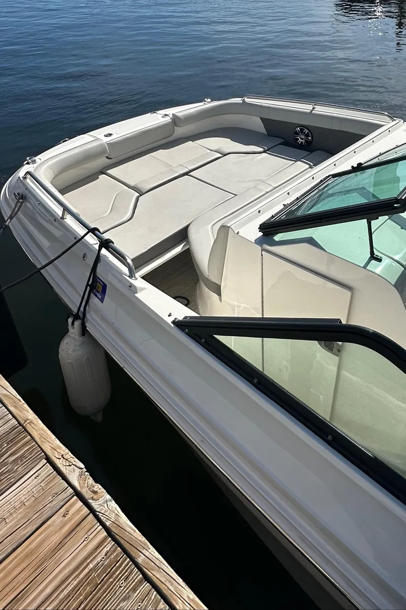 Slide: The Image of 2022 Sea Ray SDX 250 boat docked, featuring spacious seating and sleek design. - 11