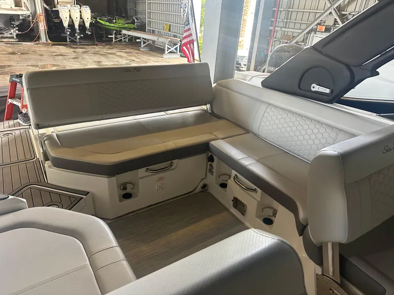 Slide: The Image of 2022 Sea Ray SDX 250 boat interior with gray seating and storage compartments. - 6