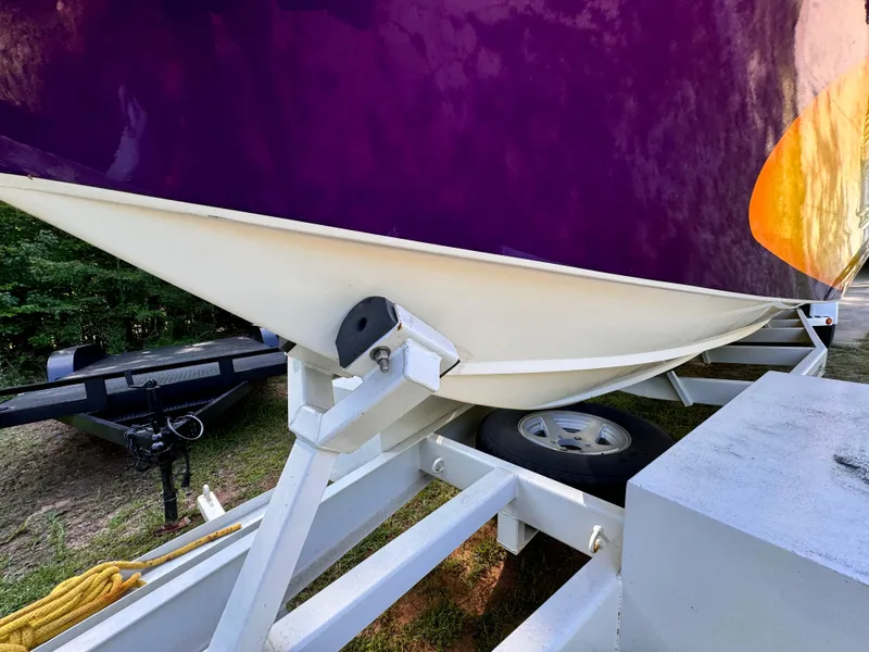 Slide: The Image of Close-up of 1990 Fountain 42 Lightning boat on trailer, purple and orange hull. - 10