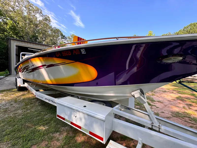 Slide: The Image of 1990 Fountain 42 Lightning boat on trailer, vibrant purple and yellow design. - 12