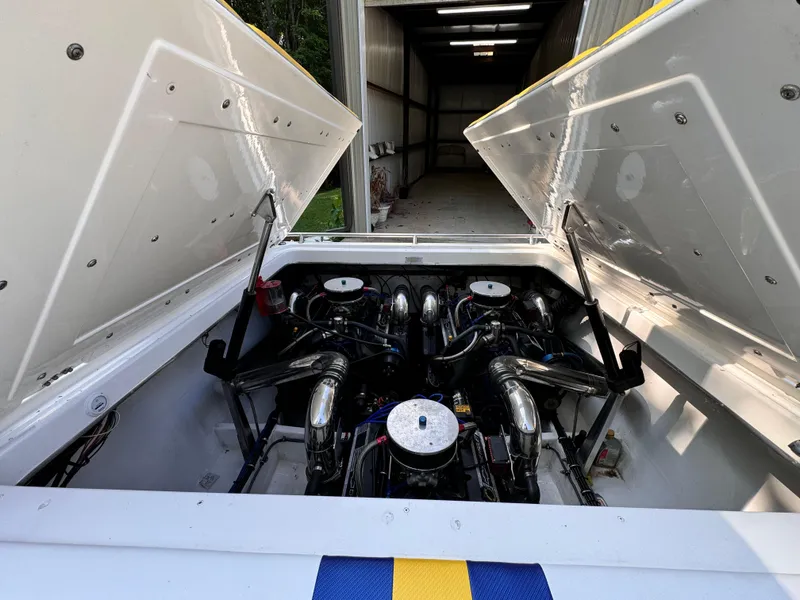 Slide: The Image of 1990 Fountain 42 Lightning boat engine compartment with dual engines in a garage. - 20