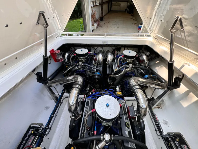 Slide: The Image of Engine compartment of a 1990 Fountain 42 Lightning boat, showcasing dual engines. - 21