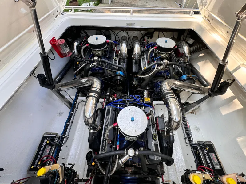 Slide: The Image of 1990 Fountain 42 Lightning boat engine compartment with dual engines and chrome components. - 22