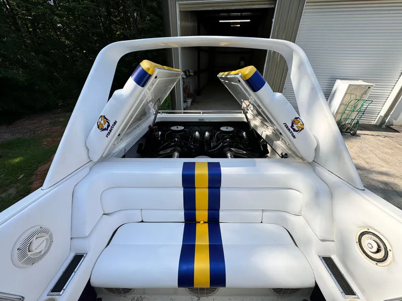 Slide: The Image of 1990 Fountain 42 Lightning boat with open engine compartment, blue and yellow striped upholstery. - 23