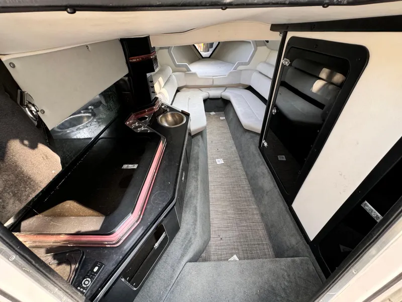 Slide: The Image of Interior of 1990 Fountain 42 Lightning boat, featuring seating and compact kitchenette. - 27