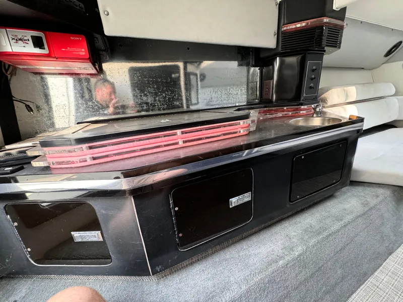 Slide: The Image of Interior of a 1990 Fountain 42 Lightning boat with sleek black and red design elements. - 29